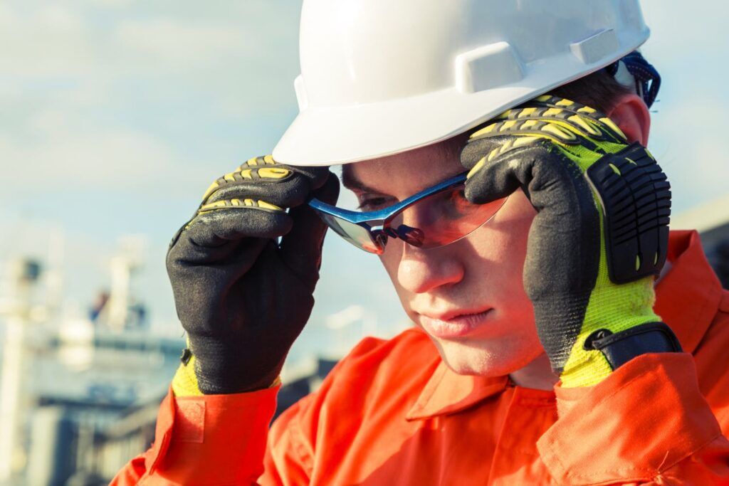 Orange robe engineer is wearing the safety goggles.