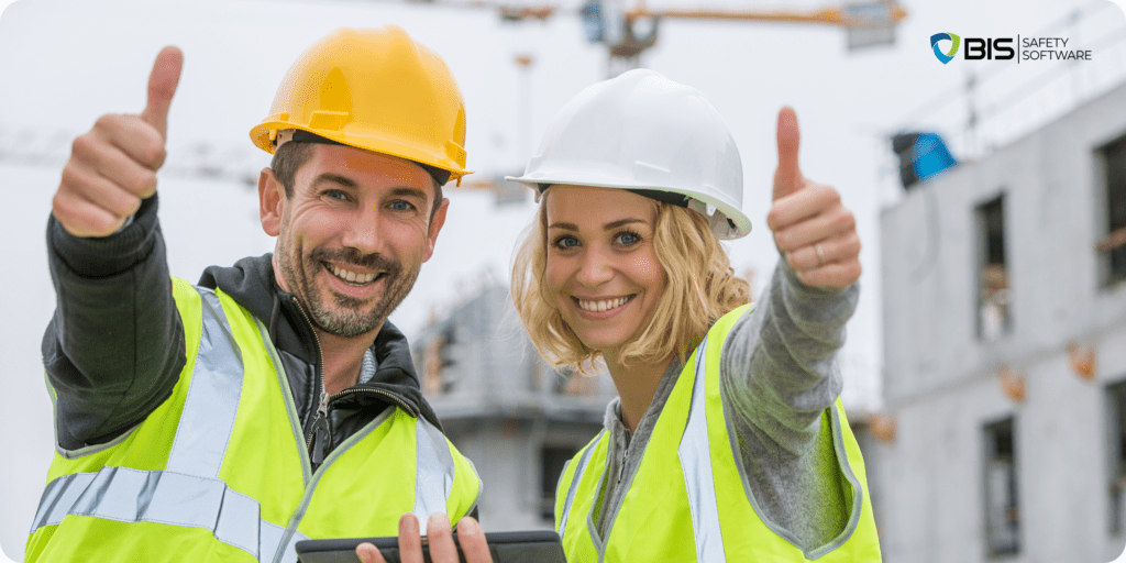 Workers showing thumbs-up, wearing PPE on Construction site