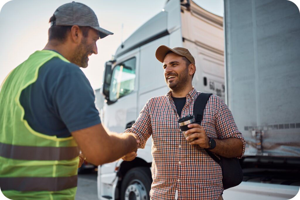 Truck driver and inspector discussing weight and dimension compliance at a checkpoint.