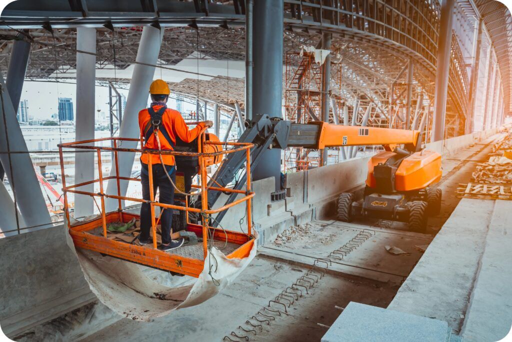 Telescopic boom lift extended for safe building maintenance by trained operator.