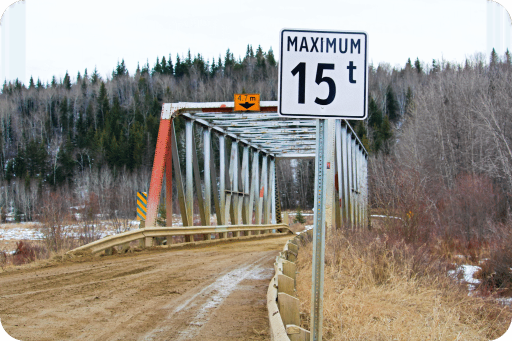 Bridge with posted height limit sign, highlighting the importance of vehicle dimension awareness.