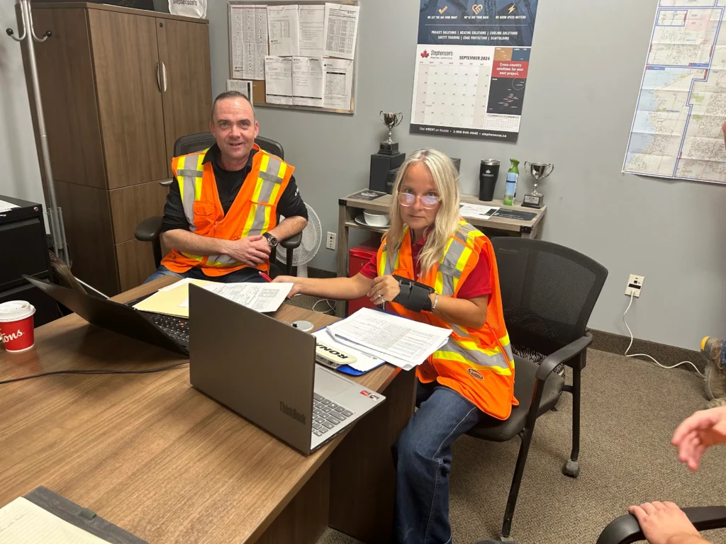 Michelle Griffin leading a safety discussion with team members in a workplace setting