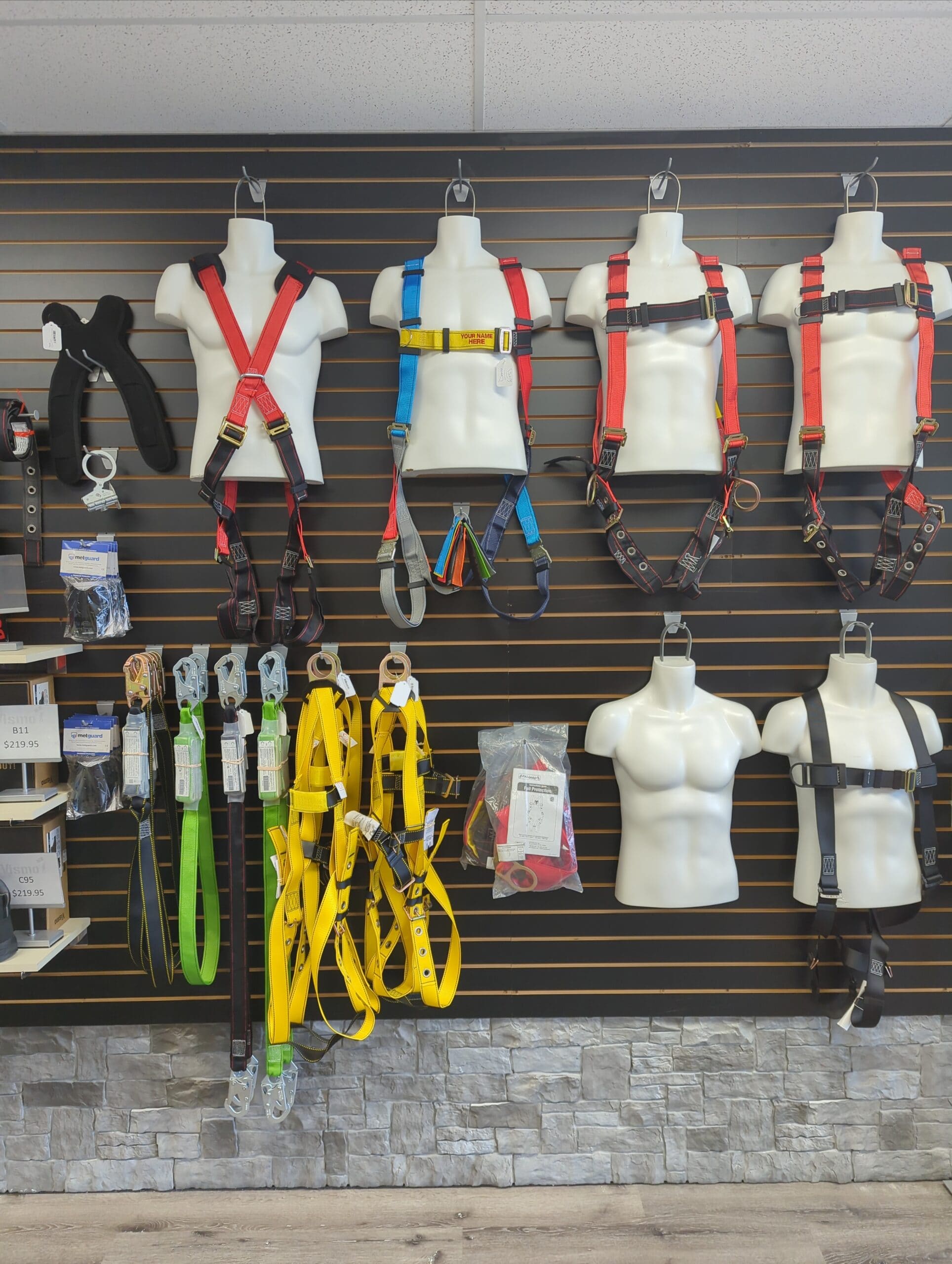 A wall of safety equipment - harnesses. cords, gloves